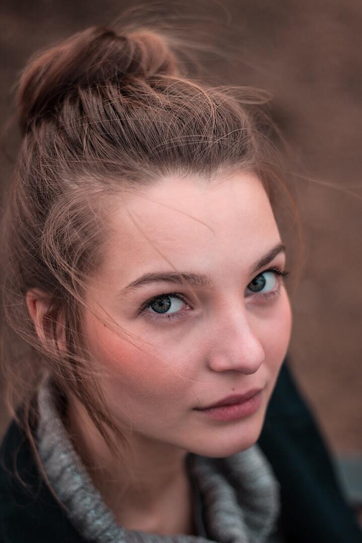 shallow focus photo of woman's face